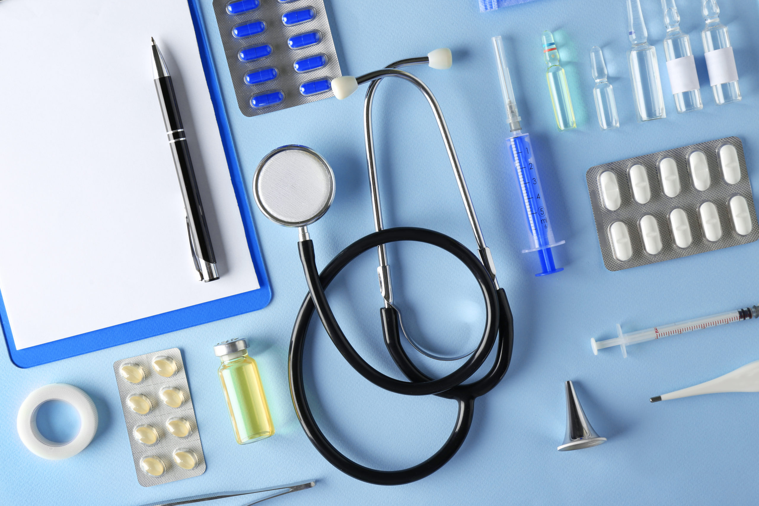 Doctor,Table,With,Medical,Items,On,Blue,Background.,Flat,Lay